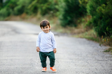 Happy baby running in forest