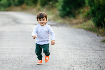 Happy baby running in forest