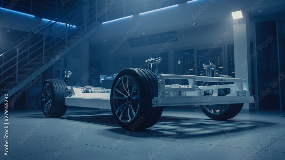 Poster concept of authentic electric car platform chassis prototype standing in industrial machinery design