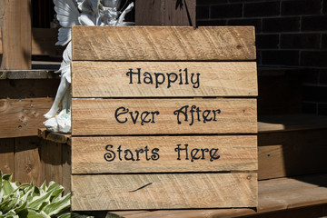 wooden happily ever after sign at wedding