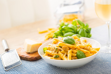 Pasta penne with chicken pieces mushrooms basil parmesan cheese and white wine.  Italian food in...