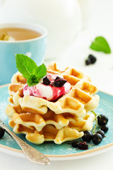 Homemade waffles with a sprig of currants. White background.