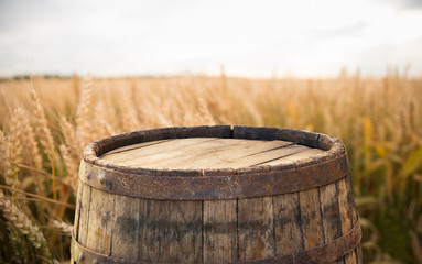 Obraz premium wood board table in front of field of wheat on sunset light. Ready for product display montage