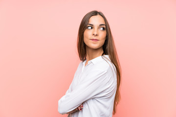 Young woman over isolated pink background laughing