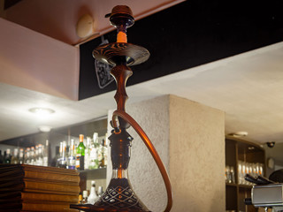 Beautiful glass hookah on the table in the bar.