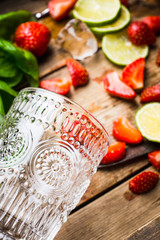 Ingredients for cocktail with strawberry and basil leaves. Selective focus. Shallow depth of field.