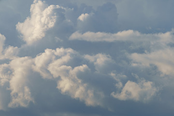 Textured, bright blue and white cumulus clouds in sky over the Moscow. Sunny summer day. Natural background. High resolution image.