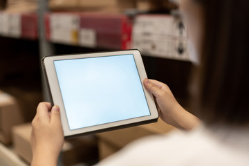 worker hand holding pad for check order pick time in smart factory warehouse