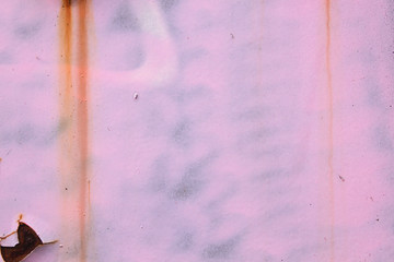 Pink graffity detail on old rusty wall