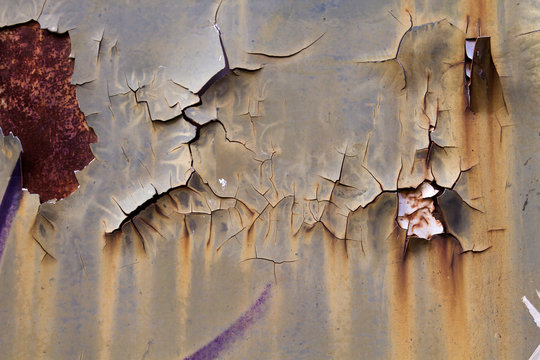 Cracked paint on old rusty wall