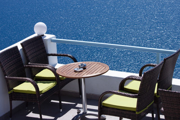 table and chairs in cafe with excellent view santorini, greece