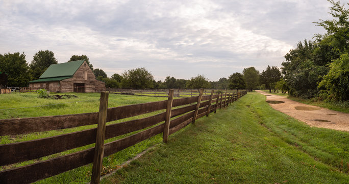 Colonial Farm on Cloudy Day with Country Gravel Road