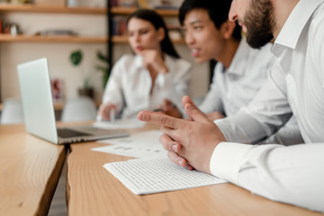 diverse group of businessmen discussing business in the office