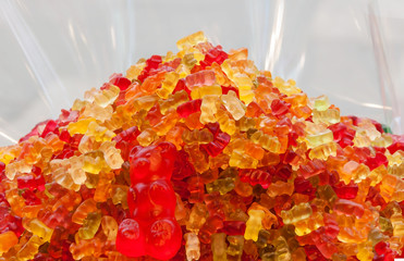 Macro photo artist of multi-colored marmalade jelly candy's. Dessert marmalade in the form of bear. The sweetness of jelly candy yellow,red and orange.
