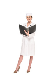 full length view of young smiling doctor in white coat with stethoscope and folder isolated on white