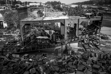 Zhuhai/China – April, 23rd 2017: Shipbreaking Yard in Zhuhai, worker dismantling with scrap metal, using gas to cut barge, ship