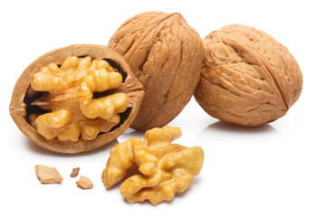 Delicious whole and broken walnuts, isolated on white background