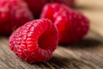 Fresh raspberries on wooden table close-up