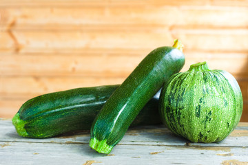 Three ripe zucchini on the windowsill in the house of farmer. Agricultural concept, farming season