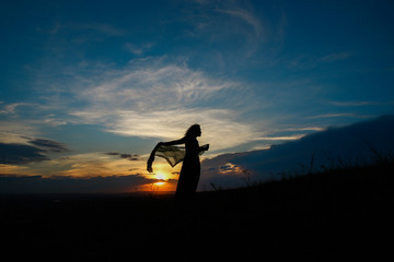 Naklejka na ściany i meble silhouette of woman on sunset