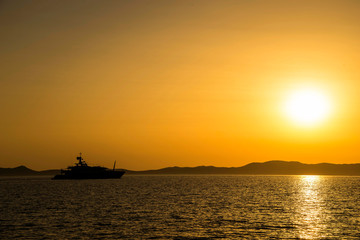 Fototapeta na wymiar yachts moored at sunset in a bay in Sardinia