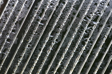 Water droplets on cellular polycarbonate, pattern and structure with variable scale and direction.