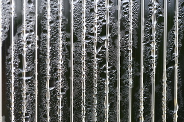 Water droplets on cellular polycarbonate, pattern and structure with variable scale and direction.