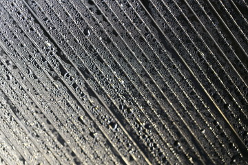 Water droplets on cellular polycarbonate, pattern and structure with variable scale and direction.