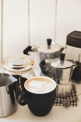 coffee of cup with equipment make coffee,mokapot, bean on white table of wood
