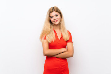 Teenager girl over isolated white background keeping the arms crossed in frontal position