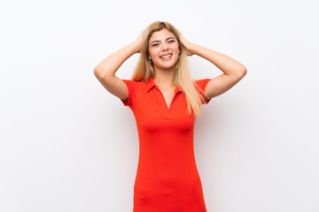 Teenager girl over isolated white background frustrated and takes hands on head