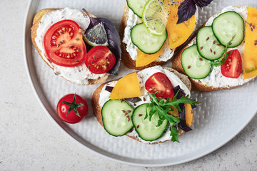 Sandwiches with cream cheese and vegetables.