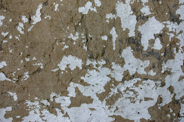 The texture of the old clay wall with whitewash