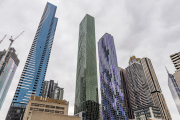 Brightly colored skyscrapers in central Melbourne, Australia, against a cloudy sky