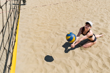 catching the ball in volleyball. taking in volleyball. young girl playing beach volleyball