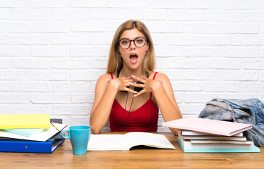 Teenager student girl at indoors surprised and shocked while looking right