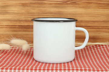 Obraz na płótnie Canvas Campfire enamel white metal mug with black line on the edge. Old tin cup design template