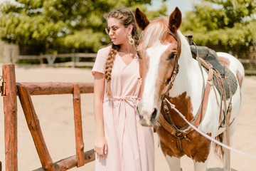 woman in a countryside with a horse from the ranch