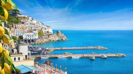 Beautiful Amalfi on hills leading down to coast, comfortable beaches and azure sea on Amalfi Coast...