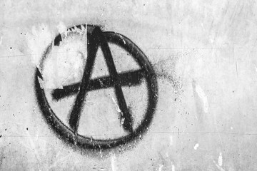 Symbol of anarchy painted on the peeling old wall