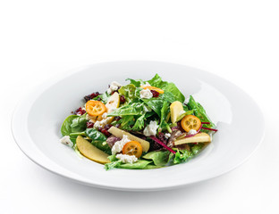Healthy fresh salad with mix greens, apple, cream cheese, cranberry, sauce and edible flowers in plate on isolated white background. Healthy food, vegetarian dieting, close up