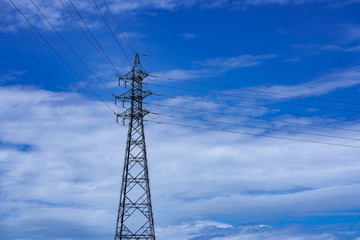 high voltage tower on background of blue sky