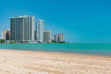 Beach view of the Skyline of Edgewater and Rogers Park with Lake Michigan in Chicago