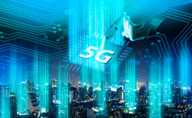 5G network digital hologram and internet of things on city background.Robot android hand holding icon 5g.5G network wireless systems,IoT(Internet of Things),communication network concept.