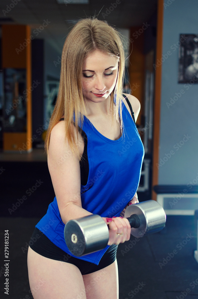 Wall mural beautiful gir in bikinil doing fitness in the gym