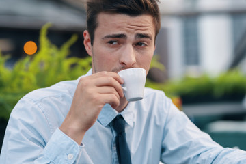 man drinking coffee in cafe