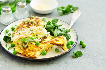 Breakfast. Frittata Italian omelet with green peas and salad.