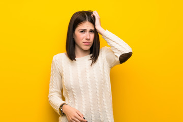 Young woman over isolated yellow wall with an expression of frustration and not understanding