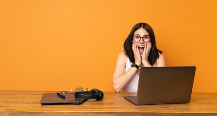 Business woman in a office with surprise and shocked facial expression