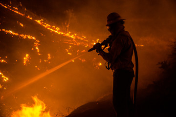 Silhouette of wildland firefighter in action